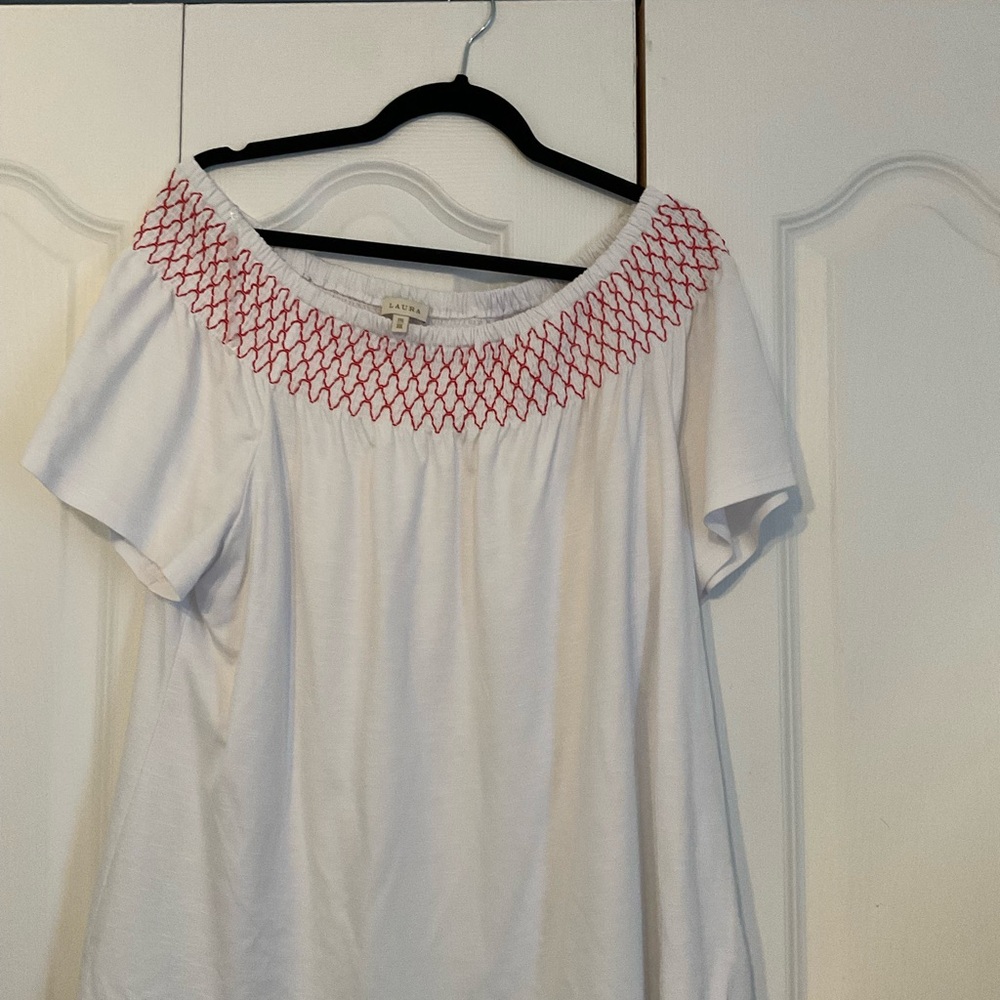 Cute top with red embroidery.